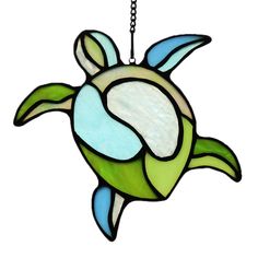 a stained glass sea turtle hanging from a chain