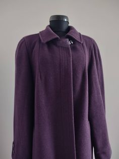 The coat is in the trendy for winter 2024/2025 plum color (Dark Purple).   It is from blend wool and mohair. This coat has a wonderful fleece-like texture, is fully lined and cuffs with bottons. It fastens with hidden buttons. On тhe neck has a decorative one-button fastening and a panel and suede eyelet. The coat has padding that gives an excellent shape to the shoulders. There are two pockets on the front, on the inside there are three spare buttons, suitable for the hidden fastening, on the c Vintage Winter, Woolen Coat, Plum Color, Winter 2024, Long Coat, Dark Purple, A Woman, Violet, Ready To Wear