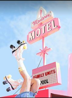 a pink motel sign with a horse statue on it's head and the words women in motion above it