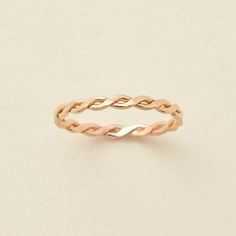 an image of a gold braid ring on a white background with the word love written in it