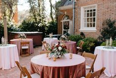 the table is set up outside with pink linens