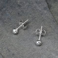 Solid Sterling Silver StudsI melted sterling silver into tiny round balls.  The the balls are soldered on to sterling silver posts with floral western style earring backs.3.5mm balls ~ perfect to wear alone or for second piercings.For more earrings: https://www.etsy.com/shop/KiraFerrer?section_id=7937255&ref=shopsection_leftnav_3To see my entire collection: https://www.etsy.com/shop/KiraFerrer?ref=hdr_shop_menu Dainty Silver Earrings With Round Beads, Tiny Classic Silver Earrings, Tiny Silver Classic Earrings, Silver Sterling Silver Earrings With Tiny Beads, Tiny Cute Sterling Silver Earrings, Tiny Round Sterling Silver Earrings, Silver Ball Earrings Studs, Silver Nickel-free Round Disc Earrings, Second Piercing