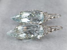 Utterly Breathtaking! These stunning aquamarine drop earrings have a striking presence! Sleek and glamorous, the elongated pear cut of the clear blue aquamarines creates a gorgeous line that draws the eye to the fiery scrolling diamond accents! Metal: 10K White Gold Gem: 2 Aquamarines totaling 48.99 Carats Gem Measurements: 31.1 x 14.1 mm, Pear Accents: 6 Diamonds totaling .10 Carats Earrings Length: 49.0 mm Earrings Width: 14.1 mm To view a video of this piece check out the link below: https:// Blue Winter Wedding, Edwardian Jewelry, Aquamarine Earrings, March Birthstone, Aqua Marine, Diamond Drops, Aquamarine Blue, March Birth Stone, Diamond Drop Earrings