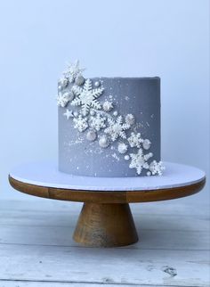 a frosted cake with white flowers on top