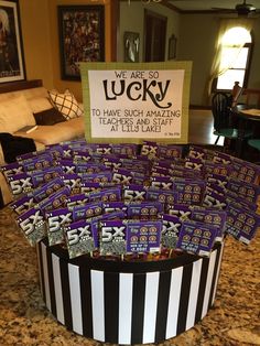 a bunch of candy sitting on top of a counter next to a sign that says we are lucky