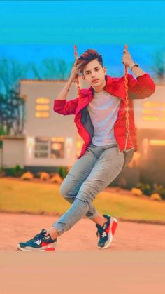 a young man is swinging on a rope