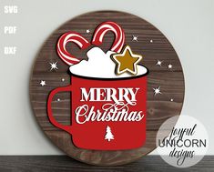 a merry christmas sign with a red coffee cup and candy canes on it's side