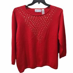 a red sweater with sequins on it