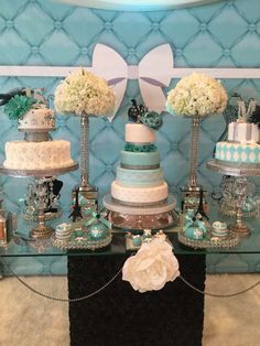 a table topped with lots of different types of cakes and cupcakes on top of each other