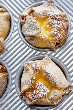 four baked pastries sitting in muffin tins