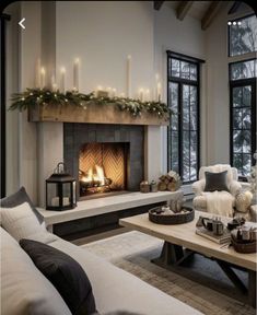 a living room filled with furniture and a fire place in front of a fireplace covered in candles