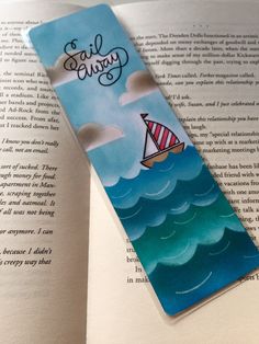 a bookmark with an image of a sailboat in the ocean on it's side