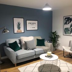 a living room filled with furniture and pictures on the wall above it's coffee table