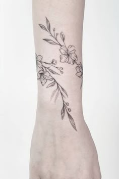 a woman's foot with a flower tattoo on it