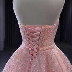 a pink dress is displayed on a mannequin