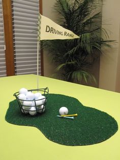 golf balls in a basket on top of a green table with a flag and ball marker