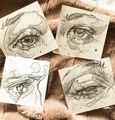 four drawings of eyes are shown on top of a blanket