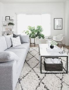 a living room filled with furniture and a white rug