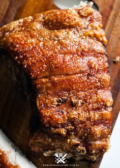 a piece of meat sitting on top of a wooden cutting board