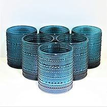 six blue glass tumblers sitting next to each other