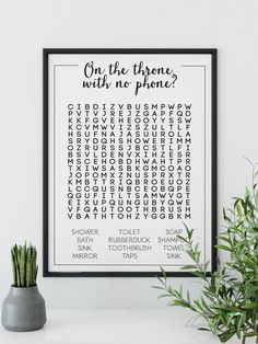 a black and white poster with the words on it next to a potted plant