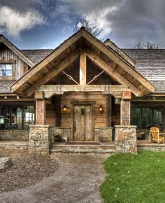 a rustic style house with stone and wood accents