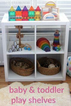 a toy shelf filled with toys on top of a wooden floor next to a white rug