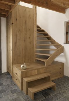 a wooden stair case next to a window