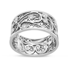 an intricately designed wedding band with diamonds in the center, on a white background