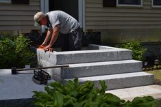 a man is working on some concrete steps