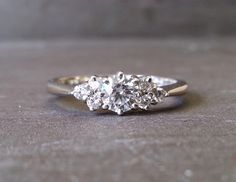 three stone diamond ring on concrete surface