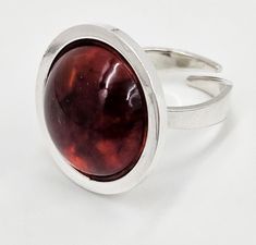 Rare Denmark Henning Ulrichsen Sterling Silver and Amber Modernist Domed Cocktail Ring Circa 1960's Size: 7.75-US / 56-EU / K 3/4-UK Face: .95"W x .95"W x .4"H (2.41cm x 2.41cm x 1.02cm) Markings: Maker's Mark 925S Handmade Denmark Weighs: 9.5g Wow! What an amazing and eye-catching ring! Ring features a sterling silver split shank band that is topped with a large faced domed Amber gemstone set in a half dome setting. It has recently been professionally polished and looks phenomenal. Would pair perfectly with the Ulrichsen necklace also listed. Henning Ulrichsen A/S is 100% a Danish family owned jewelry company that was founded in 1951 by the master goldsmith and jeweler Henning Ulrichsen. Their first workshop was placed in Herning and was moved to the current address north of Copenhagen in Amber Gemstone, Domed Ring, Maker's Mark, Jewelry Companies, Cocktail Rings, Makers Mark, Rings Statement, Denmark, Statement Rings