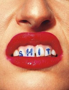 a woman's mouth with the word shut painted on it and teeth in blue