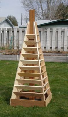 a wooden ladder sitting on top of a lush green field