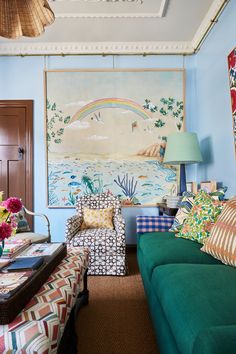 a living room filled with furniture and a painting on the wall above it's couches