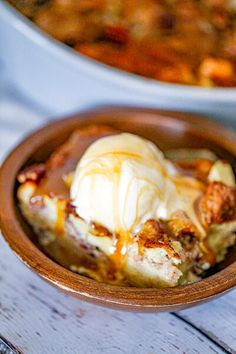 a bowl filled with food sitting on top of a wooden table