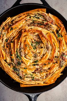 a skillet filled with pasta and cheese