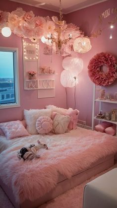 a bedroom decorated in pink and white with lots of decorations on the wall above the bed