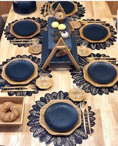 the table is set with blue plates and place mats