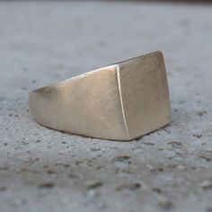 A simple, elegant yet gorgeous silver signet ring. Material: Sterling silver 925 Width:  12 mm/0.47"     Top Dimensions: approx 12mm x 12mm/0.47" X 0.47 " It can be with a shiny finish or a matte finish. Please choose from the drop-down menu. All of our pieces are made to order, so please allow for roughly 1-3 days for us to create your unique item. While we strive to make our products match the photos as closely as possible, please keep in mind that there may be slight variations. If you want t Modern Wide Band Sterling Silver Signet Ring, Silver Polished Signet Ring For Everyday, Modern Silver Engraved Ring For Everyday, Minimalist Rings With Brushed Finish As Gift, Minimalist Rings With Brushed Finish For Gift, Silver Minimalist Dome Ring For Formal Occasions, Minimalist Silver Dome Ring For Formal Occasions, Everyday Modern Silver Engraved Ring, Silver Classic Signet Ring For Everyday