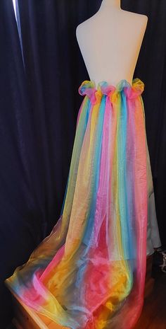 Perfect to finish off your alternative outfit, this handmade blue skirt with a frothy rainbow bustle skirt is ideal for anyone to be worn with pride!! layers of rainbow tulle sweeping out at the back designed to make a impact, finished with matching blue underskirt, laced up at the back for ease with matching ribbons.  waist to hem (back) 39 inches size UK 14. Rainbow Tulle Skirt, Bustle Skirt, Alternative Outfits, Blue Skirt, Women's Costumes, Favorite Outfit, Lace Up, Rainbow, Purses And Bags