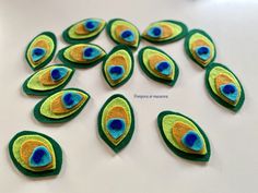 a bunch of peacock feathers sitting on top of a white table next to each other