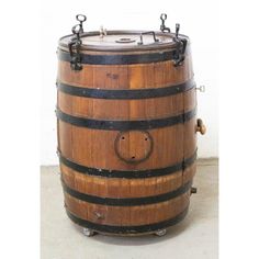 an old wooden barrel sitting on top of a cement floor