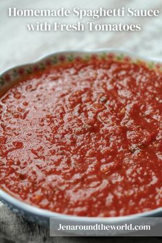 a bowl of marinara sauce sitting on top of a table