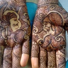 two hands with henna designs on them, one is holding an elephant and the other has