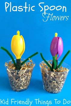 three plastic spoon flowers are in small pots