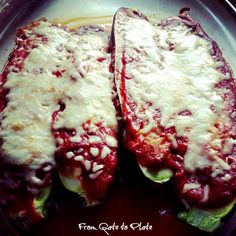 two slices of stuffed zucchini sitting on top of a pan filled with sauce