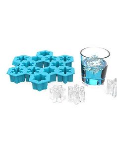 an ice tray with several pieces of ice in it and a glass filled with water