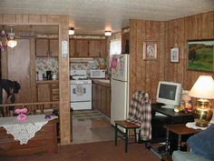 a kitchen and living room with wood paneling