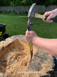 a man is holding two large tools in his hand while working on a piece of wood